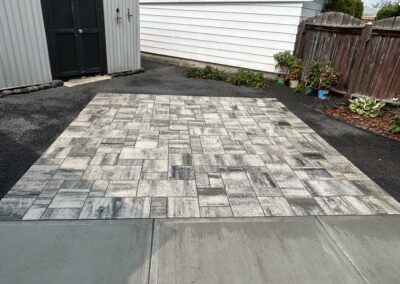 stone patio in a backyard built by Lush Landscaping