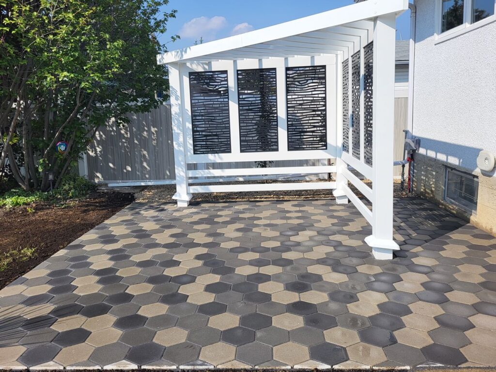 tiles and decorative fence installed in a backyard by Lush Landscaping in Edmonton