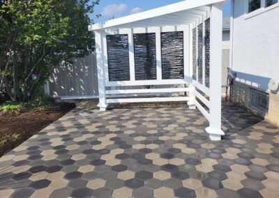 tiles and decorative fence installed in a backyard by Lush Landscaping in Edmonton