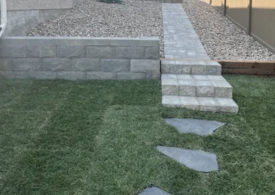 hardscape walkway and retaining wall in a backyard built by Lush Landscaping in Edmonton Alberta Canada