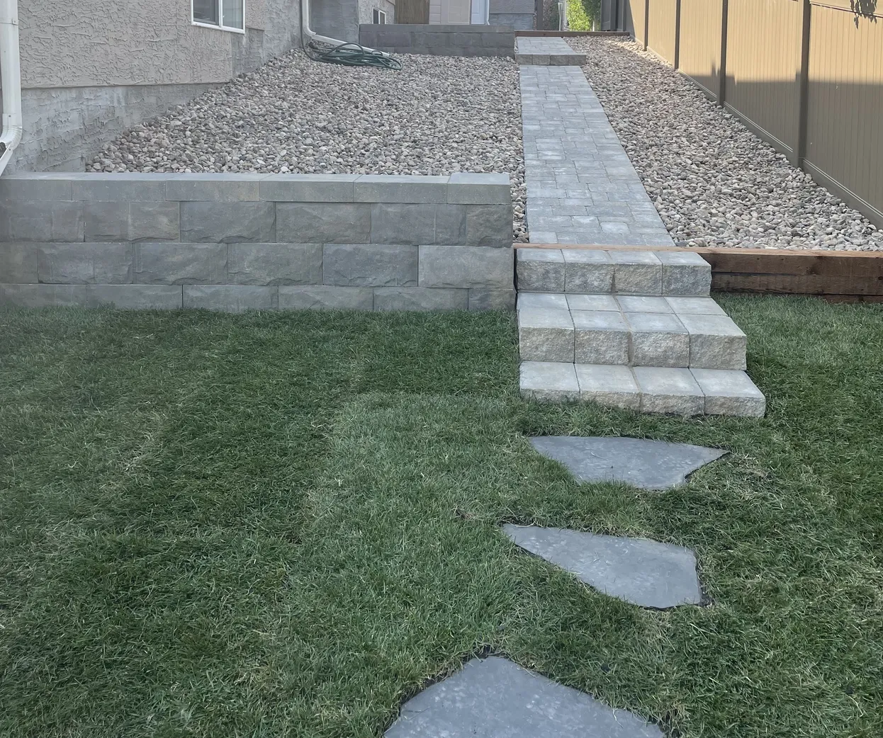 Hardscape design, walkway and retaining wall built by Lush Landscaping in Edmonton hardscape walkway and retaining wall in a backyard built by Lush Landscaping in Edmonton Alberta Canada