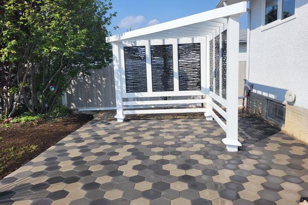 hexagonal block patio in a backyard built by Lush Landscaping