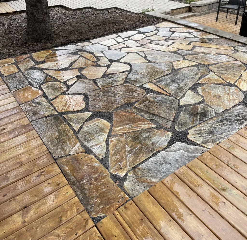 a stone patio in a backyard built by Lush Landscaping in Edmonton