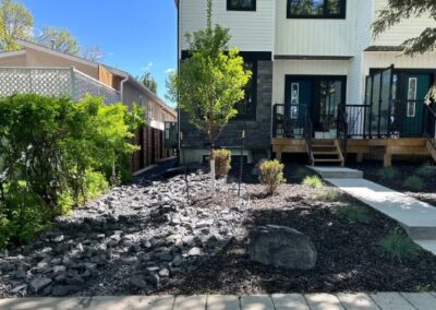 Plant selection and planting of plants outside of a nice house in Canada by Lush Landscaping and restoration ltd