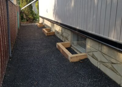 Window planters and low maintenance rocks installed by Lush Landscaping
