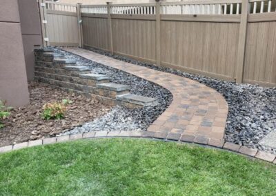 retaining wall in a backyard by Lush Landscaping