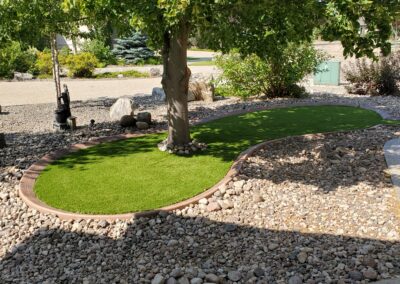 Low maintenance rocks besides a concrete walkway by Lush Landscaping
