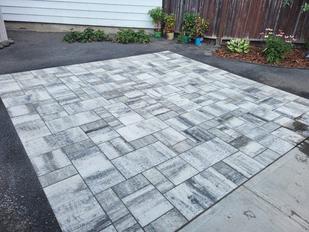 Light colored stone patio built by Lush Landscaping