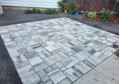 Light colored stone patio built by Lush Landscaping
