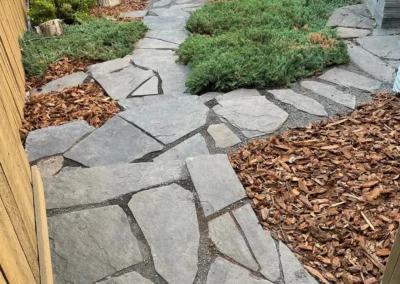 walkway construction in a backyard by Lush Landscaping