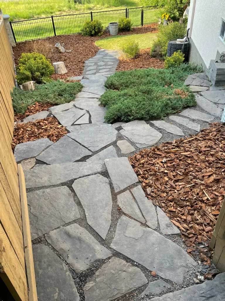 walkway construction in a backyard by Lush Landscaping