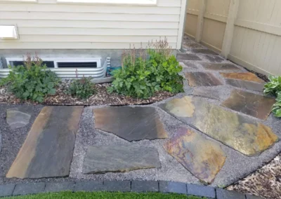 walkway made of stone in a backyard built by Lush Landscaping