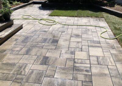 stone patio in a backyard in Edmonton built by Lush Landscaping