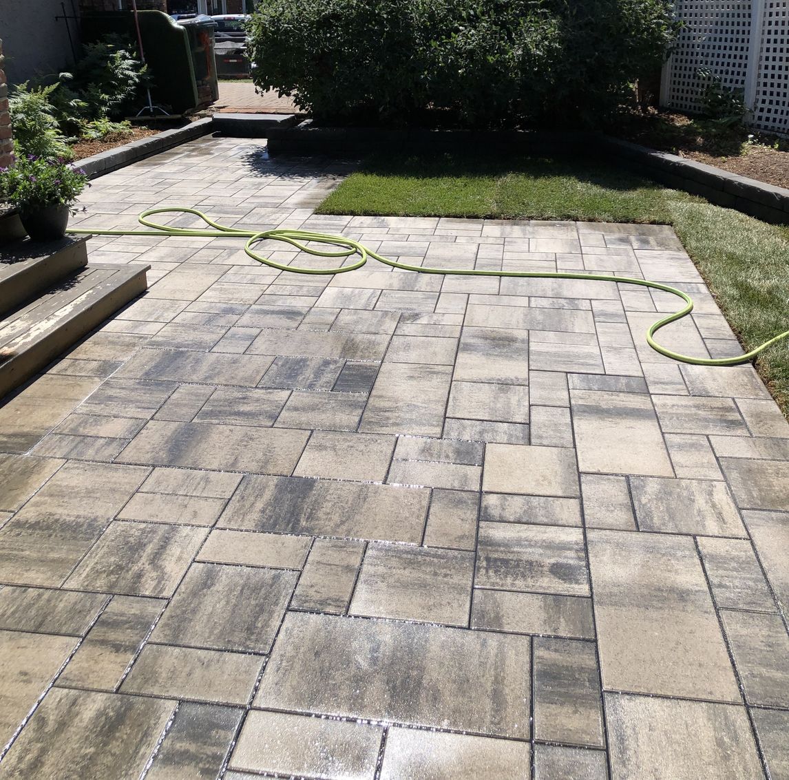 Stone patio in a backyard in Edmonton built by Lush Landscaping stone patio in a backyard in Edmonton built by Lush Landscaping