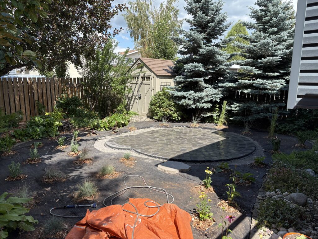 A backyard rock garden completed by Lush Landscaping
