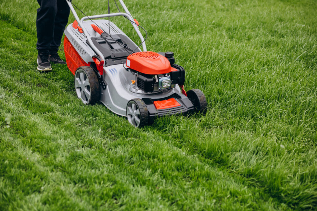 professional landscaper mowing a lawn