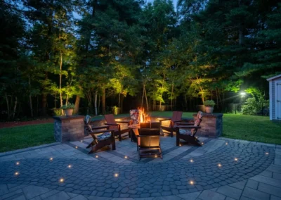 Outdoor lighting around backyard fireplace