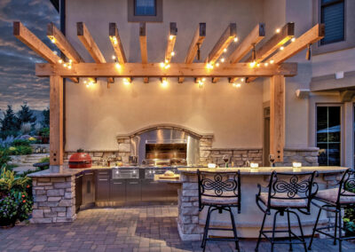 an outdoor kitchen with lighting
