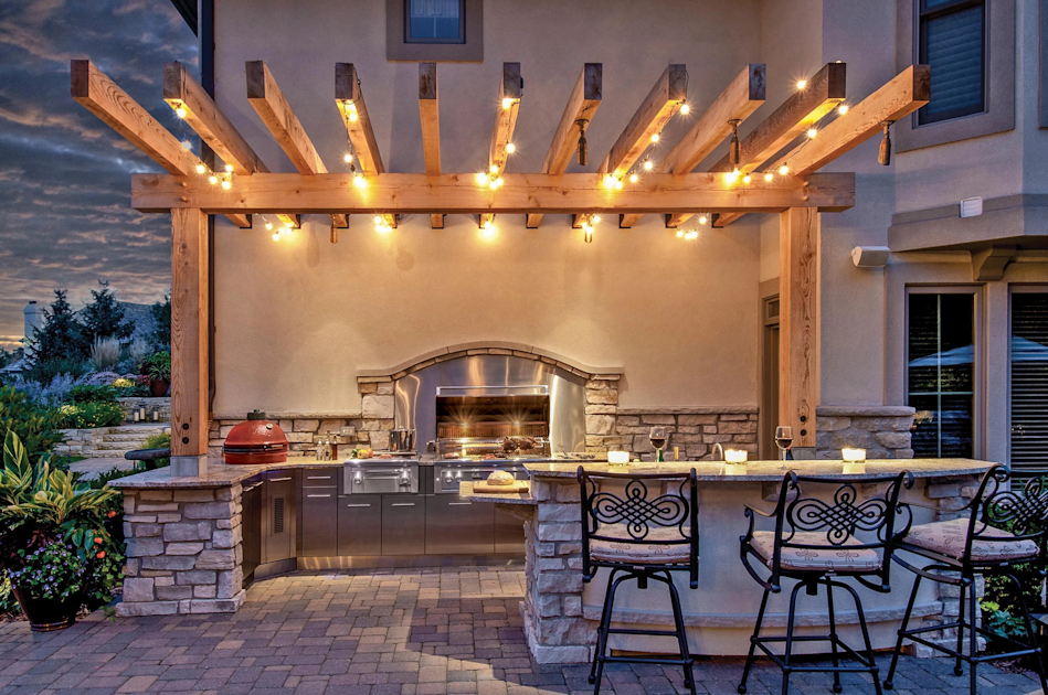 an outdoor kitchen with lighting